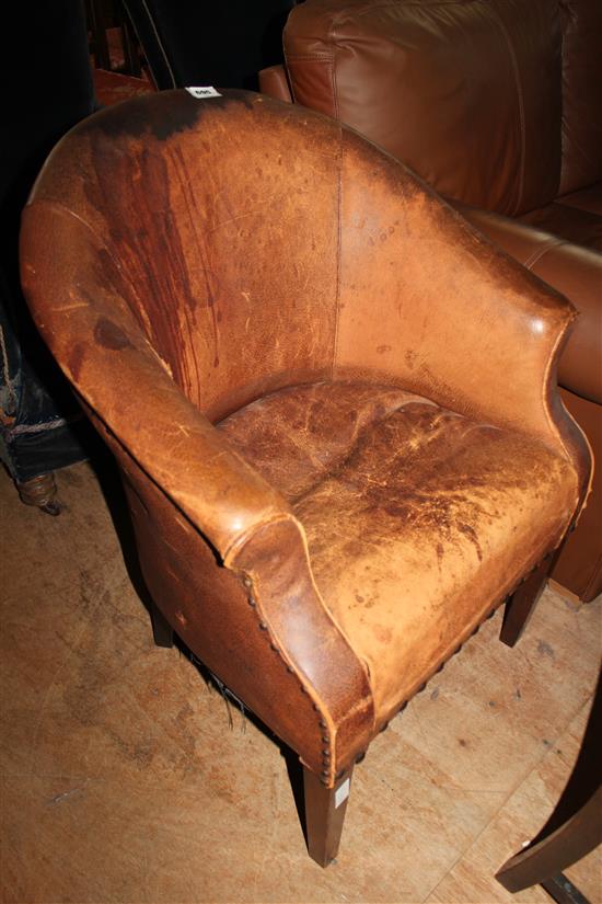 Brown leather upholstered tub shaped armchair